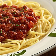 spaghetti with sauce and parsley on a plate