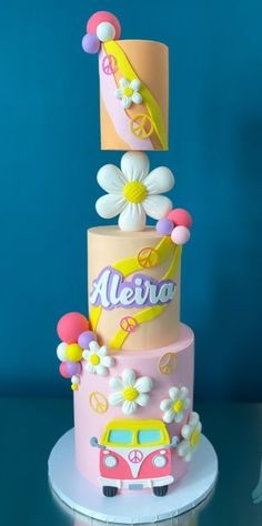 a three tiered cake decorated with flowers and the word merra on it's side