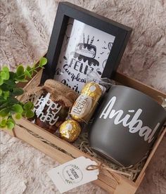 a gift box with coffee, marshmallows and cookies in it on a blanket