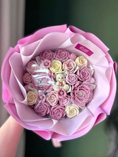 a person holding a bouquet of pink and white flowers