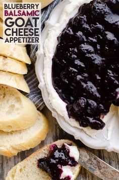 blueberry cheesecake on a plate next to sliced bread and buttered crackers