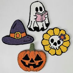 three halloween decorations are shown on a white surface