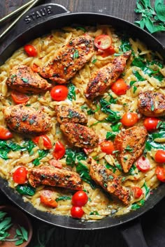 chicken and pasta with tomatoes in a skillet