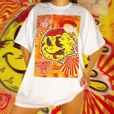 🚧 Yellow & Orange Trippy Festival Graphic T-Shirt 🚧 An original hand drawn graphic design by Mikiko! 👁 FREE WORLDWIDE SHIPPING 👁 Unisex t-shirts available in sizes  - Small - Medium - Large - XL - XXL (other sizes can be made upon request) - Ethically and sustainably manufactured - Artwork is professionally printed - no cracks or peeling - High quality heavy tee with a taped neck and sleeves - Authentic artwork - Machine wash inside out for best results (Hand-wash works even better) - Intern 80s Poster, Yellow Y2k, Rave Shirts, Y2k Graphic Tees, Retro Streetwear, Smiley Faces, 90s Nostalgia, Baby T Shirts, Smiley Face