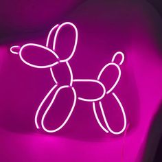 a pink neon sign with a dog on it