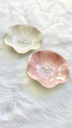 two pink and white dishes with names on them