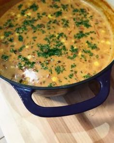 a pot filled with soup sitting on top of a wooden table