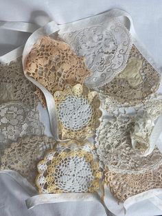 there are many different doily on the table cloths that have been placed together