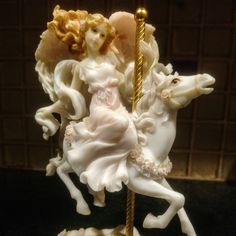 a figurine of a woman riding a horse