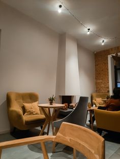 a living room filled with furniture and a fire place next to a wall mounted tv