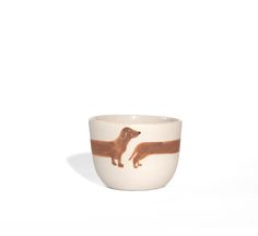 a white bowl with a brown dachshund design on it