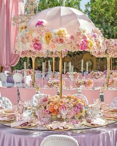 a table set up for a wedding with an umbrella