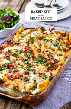 baked ziti with meat sauce in a casserole dish on a wooden table