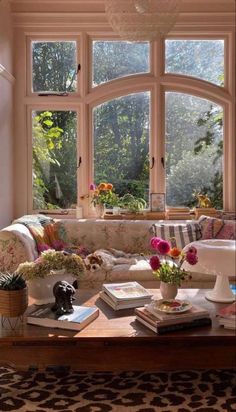 a living room filled with furniture and lots of windows