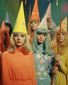 several mannequins wearing party hats and wigs are lined up behind each other