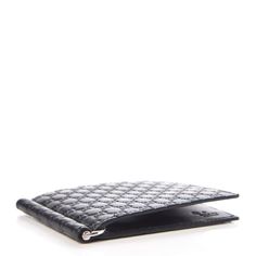 This sleek black Gucci money clip is styled with men and women in mind. It is covered with the classic microguccissima pattern we've all come to know and love. Inside the money clip are six credit card slots and silver-toned interior money clip.     Model: 544478  Black Microguccissima leather pattern  Silver-tone hardware  Six Card Slots  One Interior Money Clip  Measurements: 4.25" x 0.5" x 3.5" (LWH)  Includes authenticity cards, box, and dustbag    Made in Italy Designer Gucci Wallets For Business, Classic Gucci Wallets With Card Slots, Modern Black Gucci Wallet, Gucci Luxury Wallets With Rfid Blocking, Gucci Luxury Wallet With Rfid Blocking, Designer Gucci Wallet With Rfid Blocking, Gucci Bifold Wallet For Formal Occasions, Luxury Gucci Wallet With Rfid Blocking, Classic Gucci Bifold Wallet