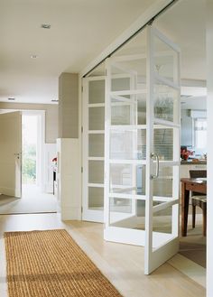 an open glass door leading to a dining room