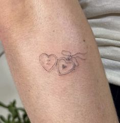 a couple of hearts tattoo on the arm