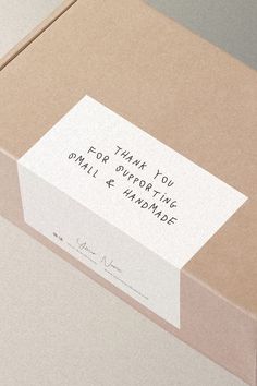 an open box with a note attached to the lid that says thank you for giving someone small & handmade