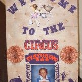 a sign that says welcome to the circus with an image of a man on it