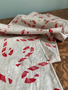 red and white napkins sitting on top of a wooden table