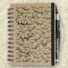 a notebook with dinosaurs drawn on it