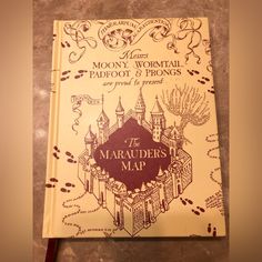 a book with an image of a castle on it's cover and the words, moony, wormtail, padfoot & prongs are printed in red