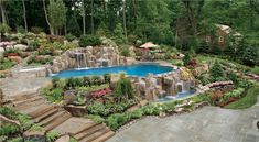 an outdoor swimming pool surrounded by landscaping