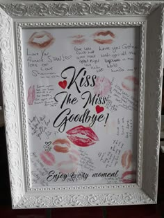 a white frame with writing on it that says kiss the miss goodbye and kisses everywhere