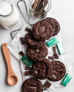 chocolate cookies and milk on a table with the words holiday mint chocolate chip cookies