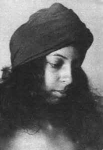 a black and white photo of a woman with long hair wearing a hat on her head