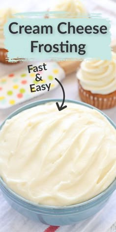 cream cheese frosting in a blue bowl next to cupcakes