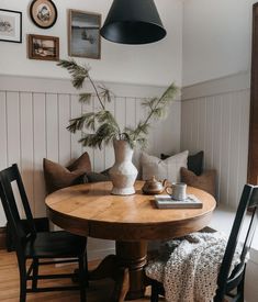 the instagram page shows an image of a table with chairs and a vase on it