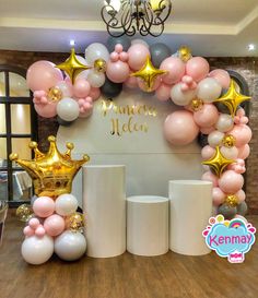 a table topped with balloons and gold crowns