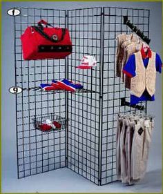 a room divider with several pieces of clothing hanging on it