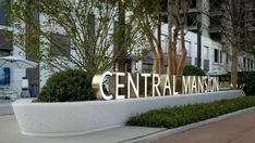 the entrance sign to central mansion is lit up