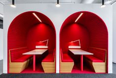 two red booths in the middle of a room