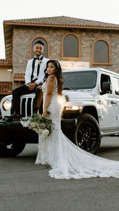 a bride and groom standing in front of a white truck