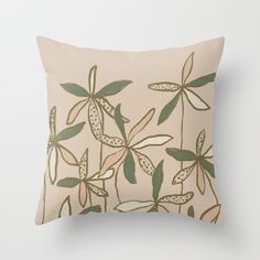 a beige pillow with green leaves on it