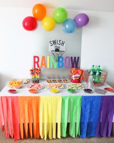 a table with balloons, cake and other items for a peppa pig birthday party