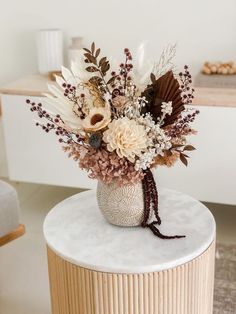 a vase filled with flowers sitting on top of a table