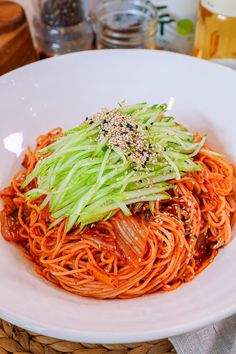 a white plate topped with spaghetti and vegetables