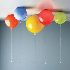 several balloons are hanging from the ceiling in a room