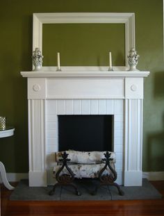 a living room with a fireplace and mirror on the wall