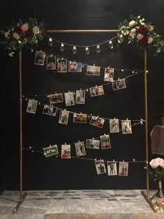 a wedding photo display with flowers and pictures hanging on the clothesline for guests to hang