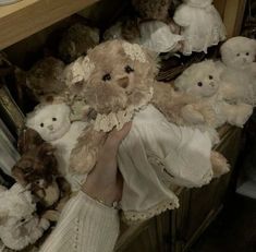 a bunch of teddy bears that are sitting on a shelf