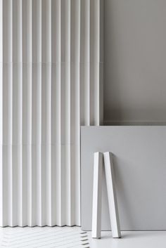 an empty white room with vertical blinds