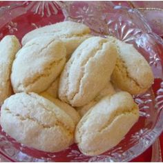 a glass bowl filled with cookies on top of a table