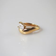 a gold ring with a single diamond on it