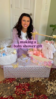 a woman sitting in front of a baby shower gift